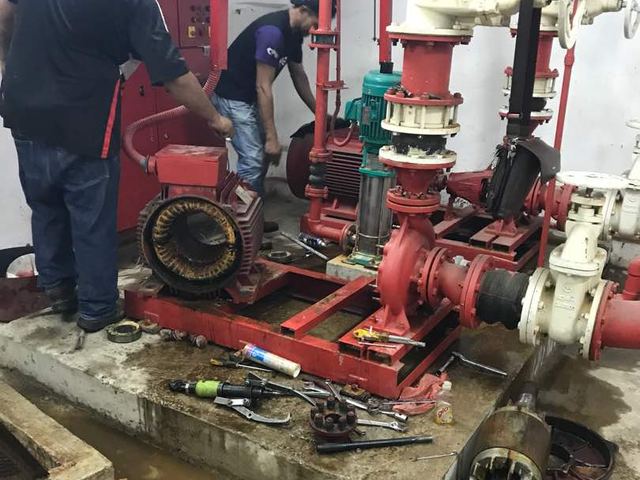 Technicians overhauling a fire pump set in the pump room