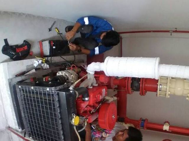 Overhead view of technicians servicing an engine-driven pump