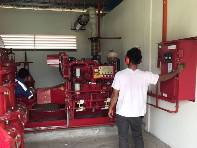 Technician checking the fire pump control panel