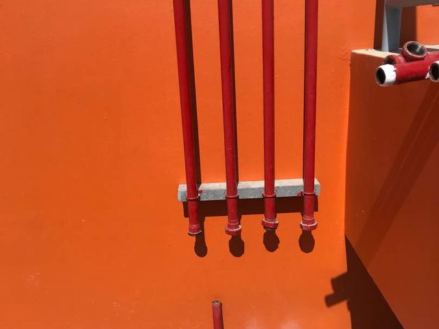 Fire pipe risers installed against a wall