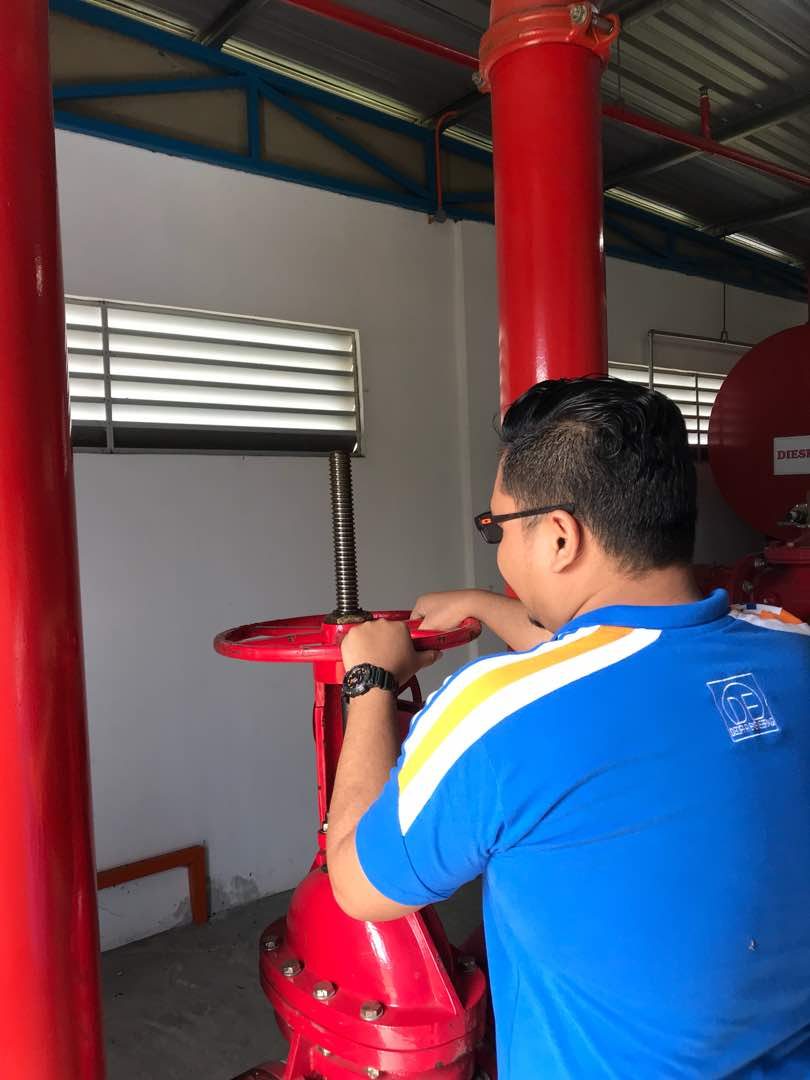 Technician operating a fire hydrant control valve